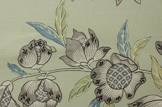  printed floral Jacobean motifs in various shades of blue, green, gray, brown, beige, and white. The pale light green background adds a touch of softness to this durable fabric, which is also soil and stain repellant and boasts a 25,000 double rub rating for long-lasting quality