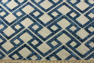 Featuring a stunning embroidered chenille fabric, P/Kaufmann© Accolade in Bristol adds a touch of elegance to any space. Its geometric design in blue against a natural background brings a modern touch, while its high durability, with 51,000 double rubs, makes it a perfect choice for upholstery, drapery, and bedding.