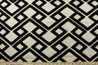 Featuring a stunning embroidered chenille fabric, P/Kaufmann© Accolade in Onyx adds a touch of elegance to any space. Its geometric design in black against a natural background brings a modern touch, while its high durability, with 51,000 double rubs, makes it a perfect choice for upholstery, drapery, and bedding.