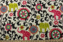 Load image into Gallery viewer, This printed outdoor fabric boasts a stunning display of elephants and medallions in lime, dark hot pink, red, gray, and black on an off-white background. With 15,000 double rubs and a 500 UV rating, this fabric is as durable as it is eye-catching. Great for&lt;span data-mce-fragment=&quot;1&quot;&gt;&nbsp;cushions, tablecloths, upholstery projects, decorative pillows and craft projects.&nbsp; Recommended to store away when not in use.&lt;/span&gt;
