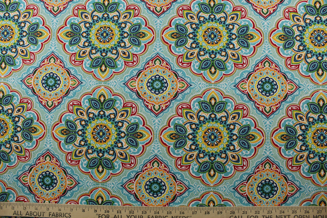 featuring a decorative medallion print in red, blue, green, yellow, orange, and opal with a touch of crisp white. With 15,000 double rubs, this durable and stylish fabric is perfect for adding a touch of elegance to any space. Plus, with 500 UV hours and water and stain resistant properties, it's great for lounge cushions, pool furniture, tablecloths, decorative pillows and upholstery projects. <span data-mce-fragment=