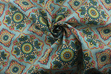 Load image into Gallery viewer, featuring a decorative medallion print in red, blue, green, yellow, orange, and opal with a touch of crisp white. With 15,000 double rubs, this durable and stylish fabric is perfect for adding a touch of elegance to any space. Plus, with 500 UV hours and water and stain resistant properties, it&#39;s great for lounge cushions, pool furniture, tablecloths, decorative pillows and upholstery projects. &lt;span data-mce-fragment=&quot;1&quot;&gt;Recommended to store away when not in use.&lt;/span&gt;
