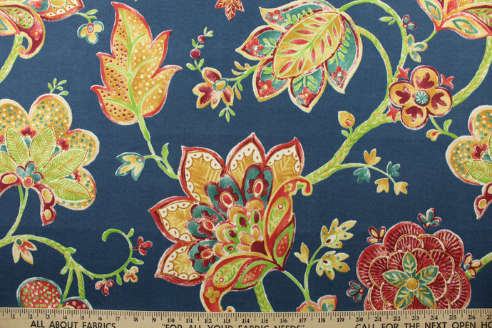 This durable fabric features a vibrant watercolor jacobean print with floral motifs in shades of red, green, gold and white against a striking navy blue background. It's also stain and water repellant and offers 500 UV hours for long-lasting use.  Perfect for lounge cushions, pool furniture, tablecloths, decorative pillows and upholstery projects. <span data-mce-fragment=