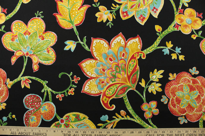 This durable fabric features a vibrant watercolor jacobean print with floral motifs in shades of red, orange, green, yellow, and white against a striking black background. It's also stain and water repellant and offers 500 UV hours for long-lasting use.  Perfect for lounge cushions, pool furniture, tablecloths, decorative pillows and upholstery projects. <span data-mce-fragment=