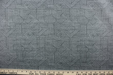 Load image into Gallery viewer, This Solarium outdoor decorative print features a geometric design in stone gray.  This versatile, long-lasting fabric can withstand up to 500 hours of sunlight, water and stain resistant and has 10,000 double rubs.  It is perfect for lounge cushions, pool furniture, tablecloths, decorative pillows and upholstery projects.  This fabric has a slightly stiff feel but is easy to work with.  

