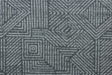 Load image into Gallery viewer, This Solarium outdoor decorative print features a geometric design in stone gray.  This versatile, long-lasting fabric can withstand up to 500 hours of sunlight, water and stain resistant and has 10,000 double rubs.  It is perfect for lounge cushions, pool furniture, tablecloths, decorative pillows and upholstery projects.  This fabric has a slightly stiff feel but is easy to work with.  
