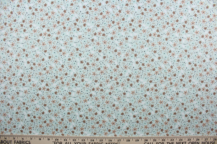 Cicely features an intricate floral pattern in shades of brown, tan, white, and black, set against a light green background.  The high-quality cotton material ensures lasting durability and softness.  It would be great for apparel, quilting, crafting and sewing projects.  