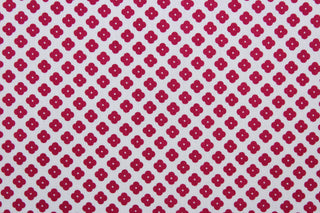 Bliss is a beautiful, lightweight fabric featuring small dark pink flowers scattered across a white background.  Perfect for any living space, it is sure to bring a splash of joy to your home. The high-quality cotton material ensures lasting durability and softness.  It would be great for apparel, quilting, crafting and sewing projects.  
