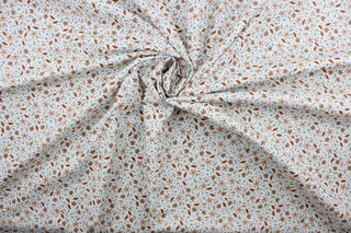 Cicely features an intricate floral pattern in shades of brown, tan, green, and black, set against a white background.  The high-quality cotton material ensures lasting durability and softness.  It would be great for apparel, quilting, crafting and sewing projects.  