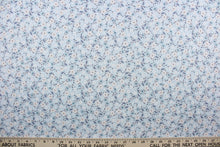 Load image into Gallery viewer,  Cicely features an intricate floral pattern in shades of light pink, slate blue, white, and black set against a light blue background.  The high-quality cotton material ensures lasting durability and softness.  It would be great for apparel, quilting, crafting and sewing projects.  
