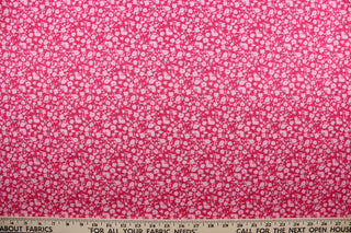 Wildflower features a timeless print of small light pink wildflowers on a simple dark pink background.  The high-quality cotton material ensures lasting durability and softness, making it perfect for your next quilting or stitching project.  The versatile lightweight fabric is soft and easy to sew.  It would be great for apparel, quilting, crafting and sewing projects.  