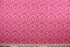 Wildflower features a timeless print of small light pink wildflowers on a simple dark pink background.  The high-quality cotton material ensures lasting durability and softness, making it perfect for your next quilting or stitching project.  The versatile lightweight fabric is soft and easy to sew.  It would be great for apparel, quilting, crafting and sewing projects.  