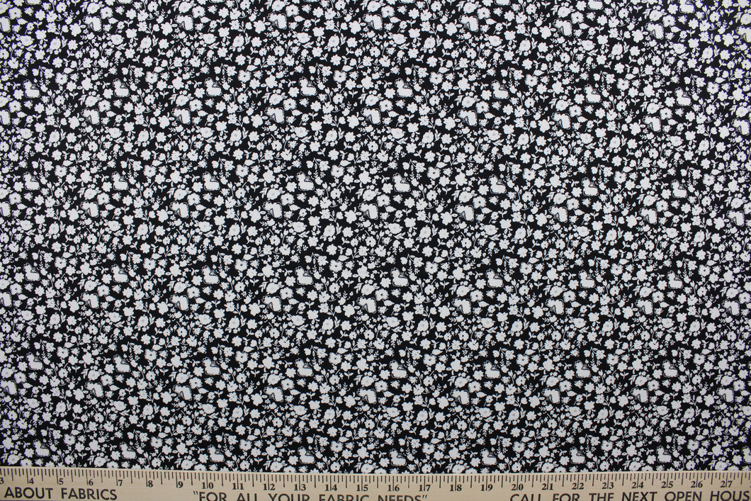 Wildflower features a timeless print of small white wildflowers on a simple black background.  The high-quality cotton material ensures lasting durability and softness, making it perfect for your next quilting or stitching project.  The versatile lightweight fabric is soft and easy to sew.  It would be great for apparel, quilting, crafting and sewing projects.  