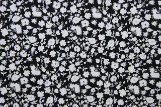 Wildflower features a timeless print of small white wildflowers on a simple black background.  The high-quality cotton material ensures lasting durability and softness, making it perfect for your next quilting or stitching project.  The versatile lightweight fabric is soft and easy to sew.  It would be great for apparel, quilting, crafting and sewing projects.  