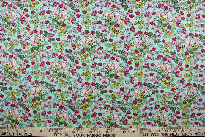 Flower Girl features a bright and cheerful floral print in a range of colors: mustard yellow, green, red, pink, white, and black on a blue background.  The high-quality cotton material ensures lasting durability and softness, making it perfect for your next quilting or stitching project.  The versatile lightweight fabric is soft and easy to sew.  It would be great for apparel, quilting, crafting and sewing projects.  