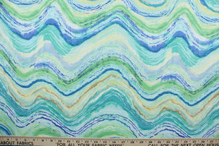 Farenor is a multi-purpose outdoor fabric featuring a wavy design in shades of blue and green, yellow, tan, and white. It is water and stain-resistant and offers U/V fade resistance up to 1,000 hours, making it a long-lasting and reliable fabric for all your outdoor needs.  Great for poolside or porches.  Uses include cushions, tablecloths, upholstery projects, decorative pillows and craft projects. 