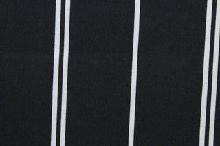 This outdoor fabric features white stripes set against a black background. It has a slightly stiff feel but easy to work with.  Solarium fabric will withstand up to 500 hours of sunlight, resists stains, water resistant and has a rating of 10,000 double rubs.  Perfect for porches, patios, and poolside.  Uses include toss pillows, cushions, upholstery, tote bags and more.