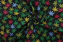 Load image into Gallery viewer,  Reefer in Rainbow offers a vibrant twist on traditional marijuana leaves.  This special fabric features a vibrant array of colors, including shades of green, red, blue, and yellow against a black background.  The high-quality cotton material ensures lasting durability and softness.  It would be great for apparel, quilting, crafting and sewing projects.  
