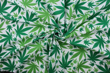 Load image into Gallery viewer,  Ganja in Green is perfect for any cannabis enthusiast.  Featuring various sized marijuana leaves in a classic green against a white background, this design packs plenty of personality.  The high-quality cotton material ensures lasting durability and softness.  It would be great for apparel, quilting, crafting and sewing projects.  
