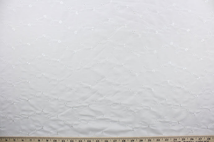 This fabric features an embroidered eyelet design highlighted with a whimsical floral pattern and a classic white hue.  Great for apparel, bedding, curtains, pillows, and/or home décor.  Its unique design ensures a lasting charm in any room.