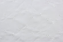 Load image into Gallery viewer, This fabric features an embroidered eyelet design highlighted with a whimsical floral pattern and a classic white hue.  Great for apparel, bedding, curtains, pillows, and/or home décor.  Its unique design ensures a lasting charm in any room.
