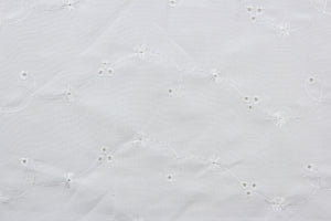This fabric features an embroidered eyelet design highlighted with a whimsical floral pattern and a classic white hue.  Great for apparel, bedding, curtains, pillows, and/or home décor.  Its unique design ensures a lasting charm in any room.