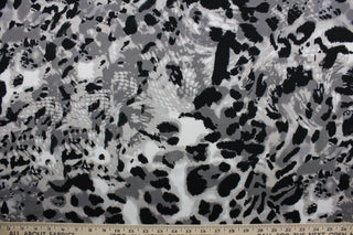 Featuring an eye-catching ocelot print in black, white, shades of gray, and light beige, the unique pattern stands out while the classic colors blend in for a sophisticated and timeless look.  The high-quality cotton material ensures lasting durability and softness.  It would be great for apparel, quilting, crafting and sewing projects.  