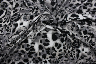 Featuring an eye-catching ocelot print in black, white, shades of gray, and light beige, the unique pattern stands out while the classic colors blend in for a sophisticated and timeless look.  The high-quality cotton material ensures lasting durability and softness.  It would be great for apparel, quilting, crafting and sewing projects.  