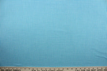 Load image into Gallery viewer, This gingham cotton fabric is the embodiment of classic American style. Boasting a traditional blue and white pattern, this lightweight fabric is perfect for adding a touch of country charm to any project. The high-quality cotton material ensures lasting durability and softness.  It would be great for apparel, quilting, crafting and sewing projects.  
