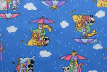 Load image into Gallery viewer,  Featuring a classic cartoon print of Noah&#39;s Ark, this cheerful design will bring a touch of fun to your home.  An array of bright colors, like pink, purple, yellow, green, black, and white, contrast against a bold blue background, and the addition of clouds, raindrops, and umbrellas make this fabric truly eye-catching.  The high-quality cotton material ensures lasting durability and softness.  It would be great for apparel, quilting, crafting and sewing projects.  
