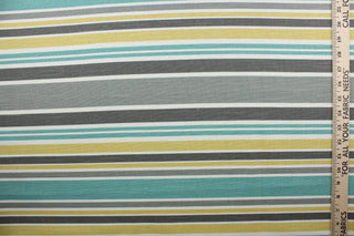 Robert Allen© Mod Layout in Fiesta is a multi-purpose fabric that features multicolored stripes in shades of gray, jade, white, and yellow.  The fabric is treated with a soil and stain repellant finish to ensure long lasting durability, with a rating of 30,000 double rubs.  It can be used for several different statement projects including window accents (drapery, curtains and swags), toss pillows, headboards, bed skirts, duvet covers and upholstery. 