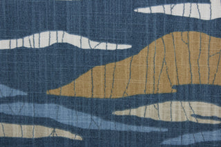 a multi purpose print featuring an array of hills in shades of slate, tan, blue, and beige to bring an understated beauty to any space.  Crafted with 65,000 double rubs, this fabric is exceptionally durable.  Additionally, a soil and stain repellant finish ensures that this fabric is easy to maintain.  It can be used for several different statement projects including window accents (drapery, curtains and swags), toss pillows, headboards, bed skirts, duvet covers, light duty upholstery, and more.