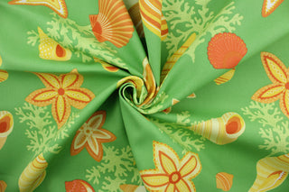  Beach Bongo in Citrus is an outdoor fabric with an eye-catching design of brightly colored seashells and coral against a lime green background.  Perfect for outdoors, the fabric is water and mildew resistant and rated to 105,000 double rubs, making it durable enough to stand up to the elements.  With hints of yellow, orange, and white, it complements any outdoor décor.  Great for upholstery, cushions, pillows, and tote bags.