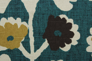  Robert Allen© Surreal Vines in Jewel fabric displays a large floral vine motif against a teal background.  Shades of tan, brown, and khaki can be seen among the vine details.  The fabric is soil and stain repellant, as well as 30,000 double rubs for durability.  It can be used for several different statement projects including window accents (drapery, curtains and swags), toss pillows, headboards, bed skirts, duvet covers, upholstery, and more.