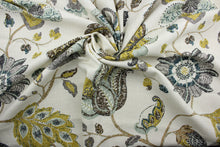 Load image into Gallery viewer,  a classic mottled floral and leaf print.  Its lovely aloe, brown, gray, midnight blue, and goldenrod colors blend beautifully against an ivory background, and it offers top-notch durability with 30,000 double rubs and stain and water repellent protection. It can be used for several different statement projects including window accents (drapery, curtains and swags), toss pillows, headboards, bed skirts, duvet covers, upholstery, and more.
