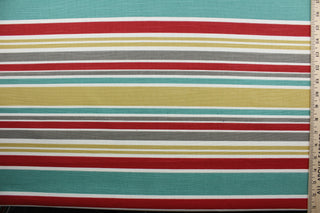  Robert Allen© Mod Layout in Poppy is a multi-purpose fabric that features vivid, multicolored stripes in shades of poppy, gray, gold, white, and dark turquoise.  The fabric is treated with a soil and stain repellant finish to ensure long lasting durability, with a rating of 30,000 double rubs.  It can be used for several different statement projects including window accents (drapery, curtains and swags), toss pillows, headboards, bed skirts, duvet covers and upholstery. 