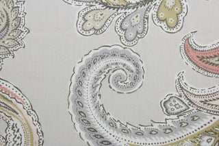 a multi-purpose, large-scale paisley print fabric with blush, light pink, blue/gray, green, and white accents on a pale gray background. This fabric offers an impressive 30,000 double rubs and is treated with a soil and stain repellant finish to ensure durability and ease of maintenance.  It can be used for several different statement projects including window accents (drapery, curtains and swags), toss pillows, headboards, bed skirts, duvet covers, upholstery, and more.