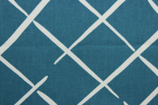 This Robert Allen© Cove End in Pool fabric features a stylish geometric print in blue green, and white.  It has a soil and stain repellant finish and a durability of 100,000 double rubs, making it a great choice for multipurpose use.  It can be used for several different statement projects including window accents (drapery, curtains and swags), toss pillows, headboards, bed skirts, duvet covers, upholstery, and more.