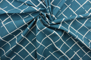 This Robert Allen© Cove End in Pool fabric features a stylish geometric print in blue green, and white.  It has a soil and stain repellant finish and a durability of 100,000 double rubs, making it a great choice for multipurpose use.  It can be used for several different statement projects including window accents (drapery, curtains and swags), toss pillows, headboards, bed skirts, duvet covers, upholstery, and more.