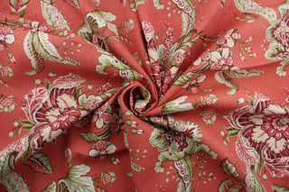 Featuring a stunning floral pattern in rust, terra cotta, green, purple, and brown, this fabric is sure to bring a vibrant touch to any space.  The coral background adds depth to the print, and it is finished with a soil and stain-resistant finish.  It can be used for several different statement projects including window accents (drapery, curtains and swags), toss pillows, headboards, bed skirts, duvet covers, upholstery, and more.