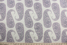 Load image into Gallery viewer, Create a statement piece with Robert Allen© Paisley Purple in Eggplant. This multi-purpose, high-end jacquard fabric features large paisley petals in shades of purple on an antique white background. It offers 30,000 double rubs and can be used for upholstery, cushions, pillows, and craft projects.
