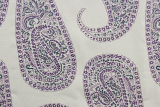 Create a statement piece with Robert Allen© Paisley Purple in Eggplant. This multi-purpose, high-end jacquard fabric features large paisley petals in shades of purple on an antique white background. It offers 30,000 double rubs and can be used for upholstery, cushions, pillows, and craft projects.