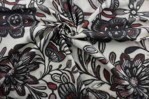 The large-scale floral print features shades of black, gray, henna, and cream on an off-white background. The durable fabric has a 30,000 double rub rating and is soil and stain resistant, making it a practical and fashionable choice.  It can be used for several different statement projects including window accents (drapery, curtains and swags), toss pillows, headboards, bed skirts, duvet covers, upholstery, and more.