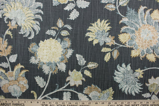 Charlotte is a multi-use fabric featuring a large floral print.  This fabric includes shades of gray, tan, blue, ivory, and a graphite background, providing a unique and sophisticated design.  It can be used for several different statement projects including window accents (drapery, curtains and swags), decorative pillows, hand bags, bed skirts, duvet covers, upholstery and craft projects.  
