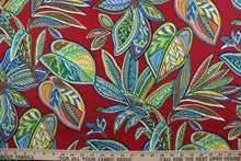 Load image into Gallery viewer, Crestwood is for outdoor use, with a beautiful flowing leaf design featured in shades of blue, green, yellow, orange and white against a red background.  It is UV fade, water and stain resistant, with a durability rating of 15,000 double rubs. Perfect for porches, patios and pool side.  Uses include toss pillows, cushions, upholstery, tote bags and more.  
