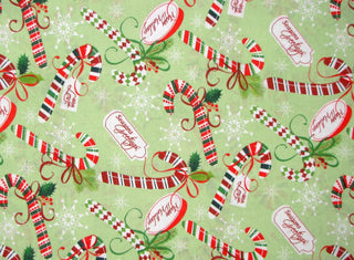 Christmas Happy Holidays Candy Cane Toss Quilting Fabric in Green