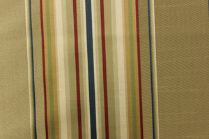 This stunning yarn dyed fabric features a multi width striped pattern in blue, red, gold, green and shades of khaki