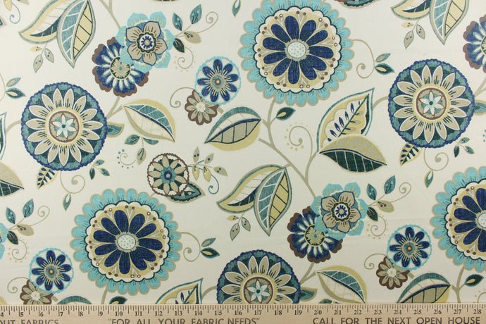 This fun fabric features a floral pattern in blue, brown, teal, khaki, dark green, and a brown gray  on a off white background. 