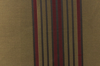 This fabric features a striped design in brown and burgundy colors on a dark gold background. 