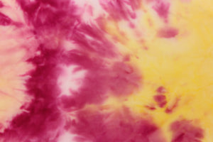 This lycra features a 8 way stretch in a fun tie dye design, with colors of  yellow and shades of pink with hints of orange. 